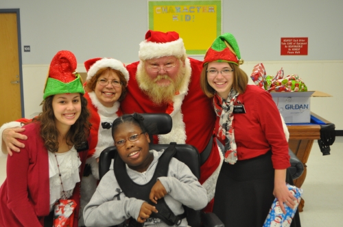 Group of people standing with Santa Claus