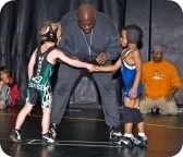 two young boys shaking hands before a wresting match